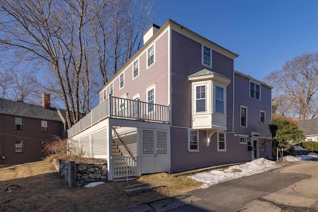 view of front facade with stairway and a deck