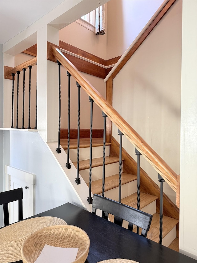 stairs featuring wood finished floors