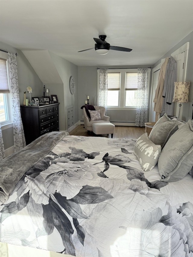 bedroom with baseboards, a ceiling fan, and wood finished floors