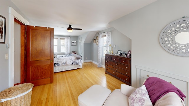 bedroom featuring light wood-style floors, baseboards, and ceiling fan