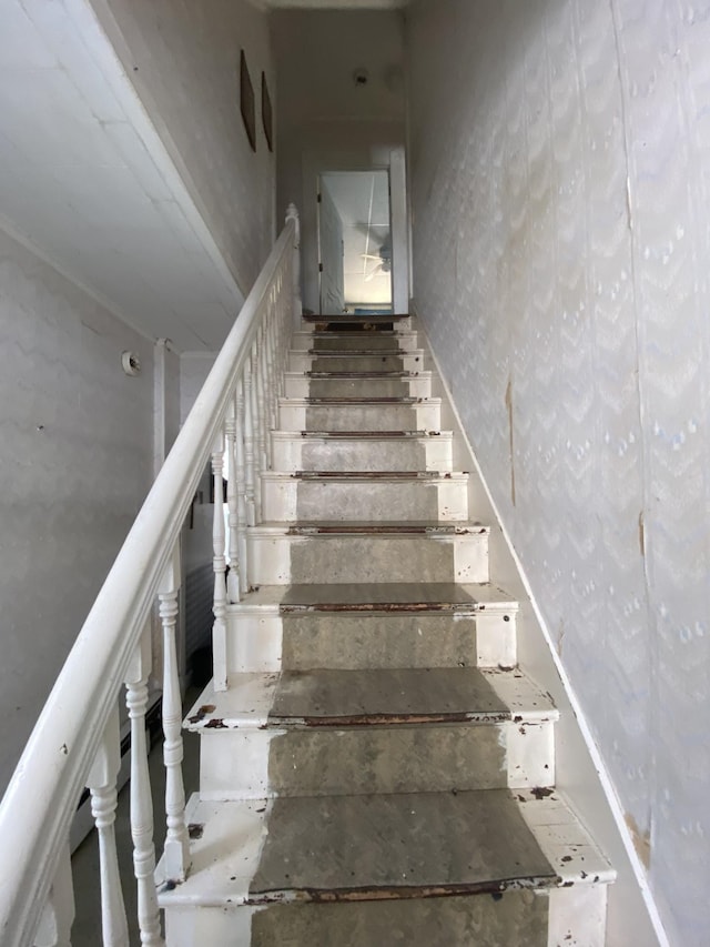 stairs with wallpapered walls