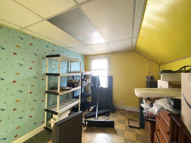 office area featuring lofted ceiling, a paneled ceiling, and baseboards