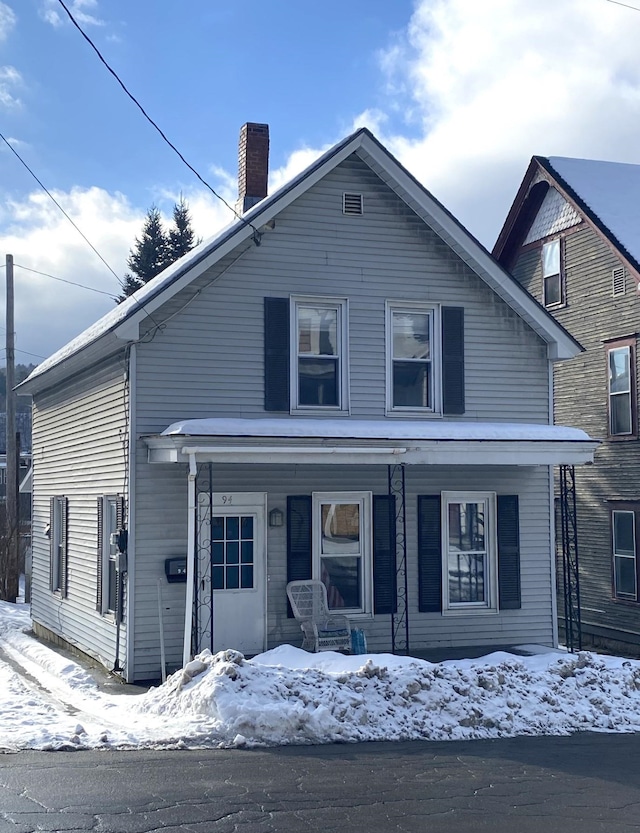 view of front of property with covered porch and a chimney