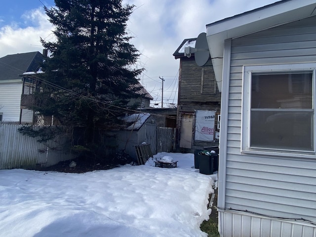 snowy yard with fence