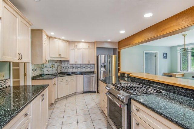 kitchen featuring a sink, backsplash, recessed lighting, stainless steel appliances, and light tile patterned floors