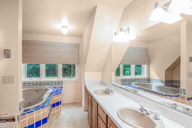 full bath with double vanity, a tub with jets, tile patterned floors, and a sink