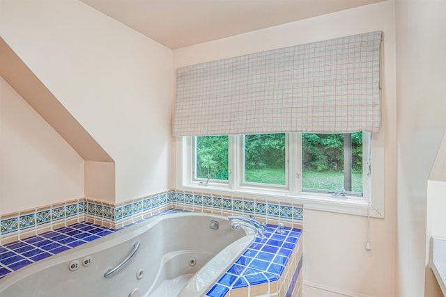 full bathroom with a healthy amount of sunlight and a tub with jets