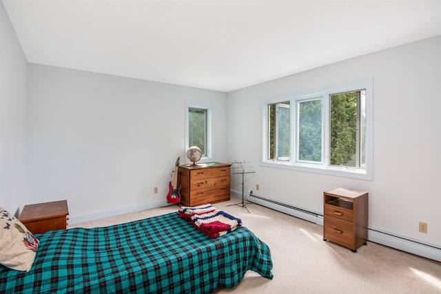 bedroom featuring light colored carpet, a baseboard heating unit, baseboards, and a baseboard radiator