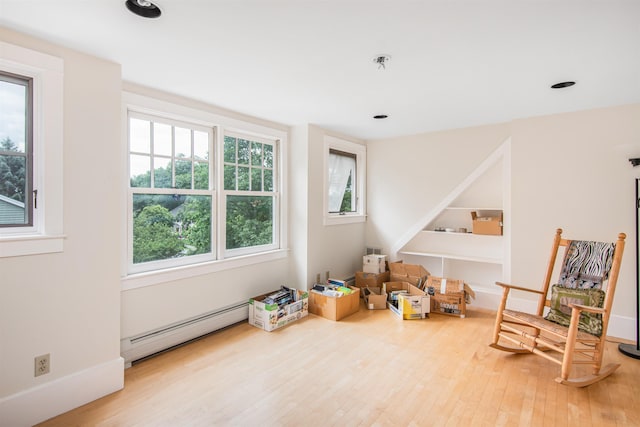 rec room featuring recessed lighting, a baseboard heating unit, baseboards, and wood finished floors