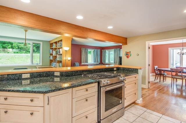 kitchen with recessed lighting, plenty of natural light, stainless steel range with gas stovetop, and light tile patterned flooring