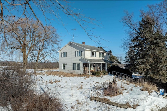 view of front of property featuring a porch and a chimney