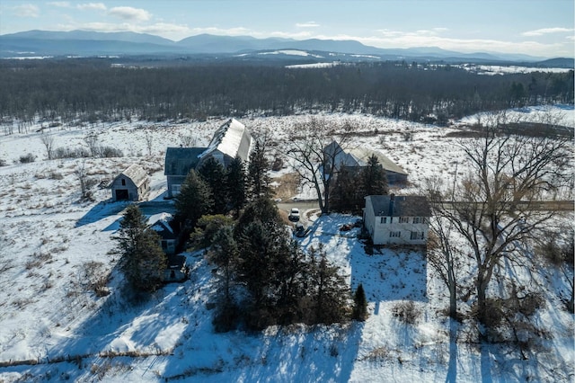 snowy aerial view featuring a mountain view