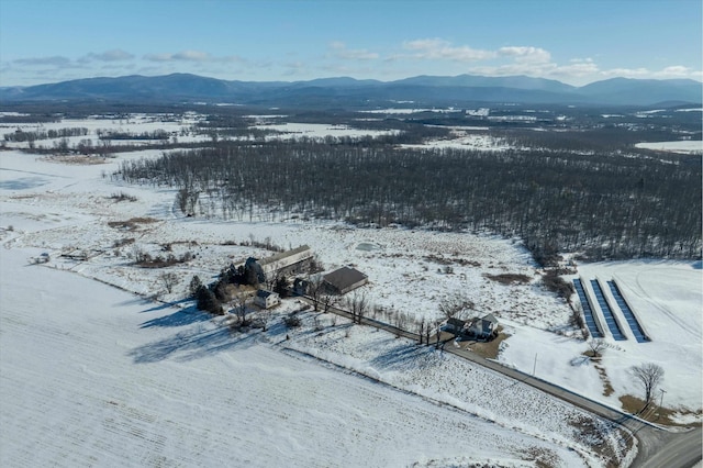 snowy aerial view featuring a mountain view