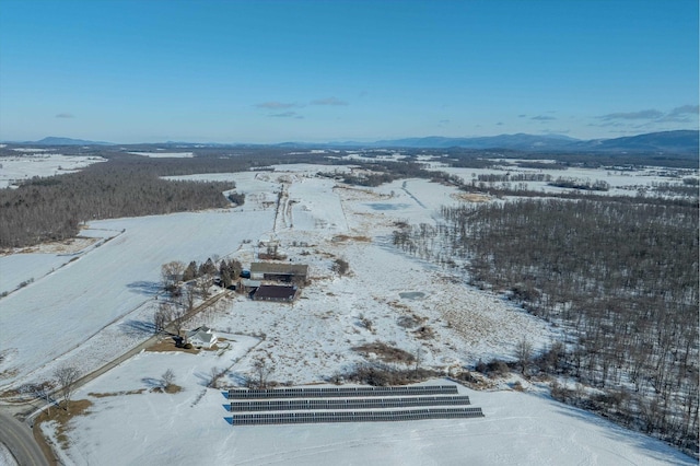 snowy aerial view with a mountain view