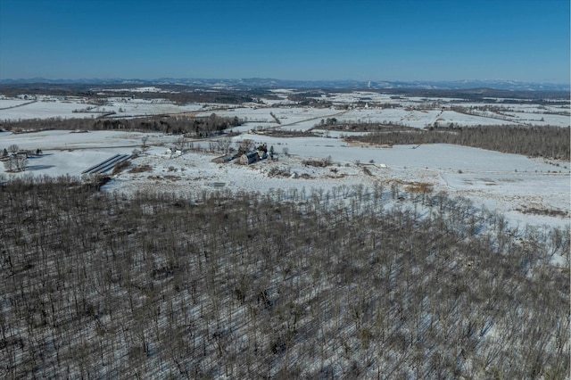 snowy aerial view featuring a mountain view