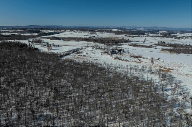 snowy aerial view with a mountain view