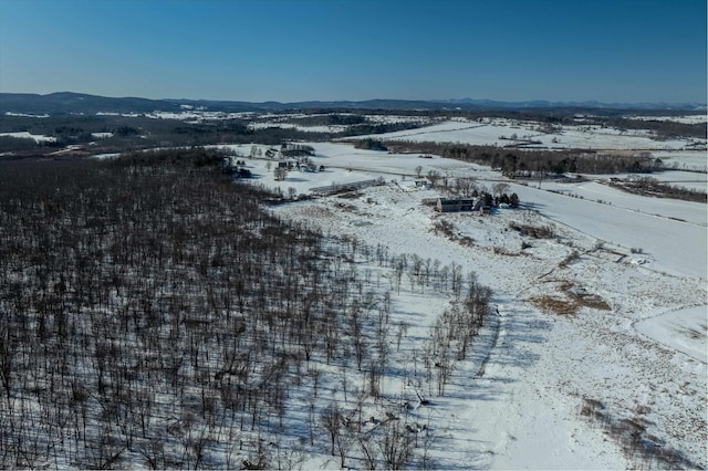 snowy aerial view featuring a mountain view