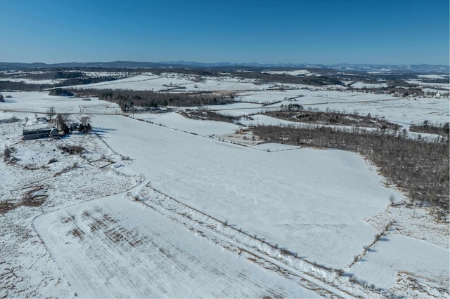 snowy aerial view with a mountain view