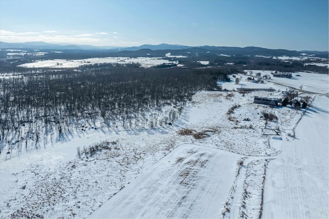 snowy aerial view featuring a mountain view