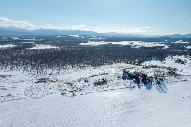 snowy aerial view featuring a mountain view