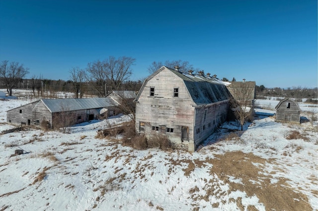 exterior space with a barn, an outbuilding, and a gambrel roof