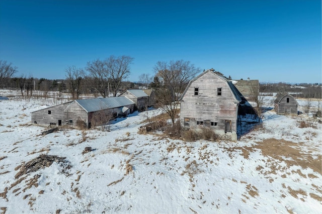 exterior space featuring a gambrel roof, a barn, a garage, and an outdoor structure