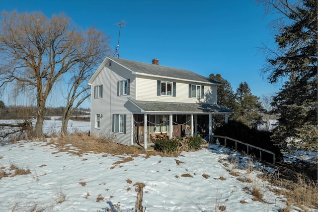 view of front of house featuring a chimney