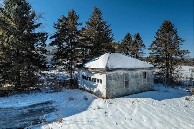 snow covered garage featuring a garage