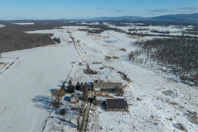 snowy aerial view featuring a mountain view