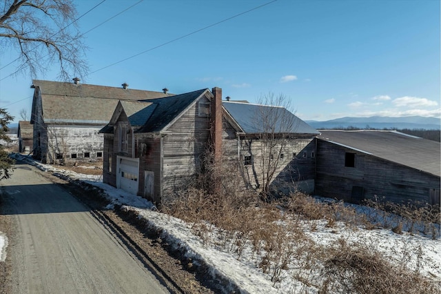 view of snowy exterior featuring a garage