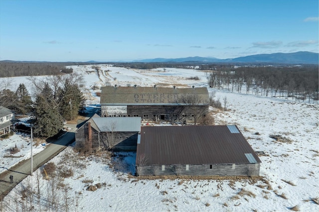 snowy aerial view featuring a mountain view