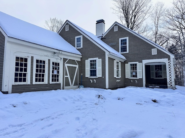 rear view of house featuring a chimney