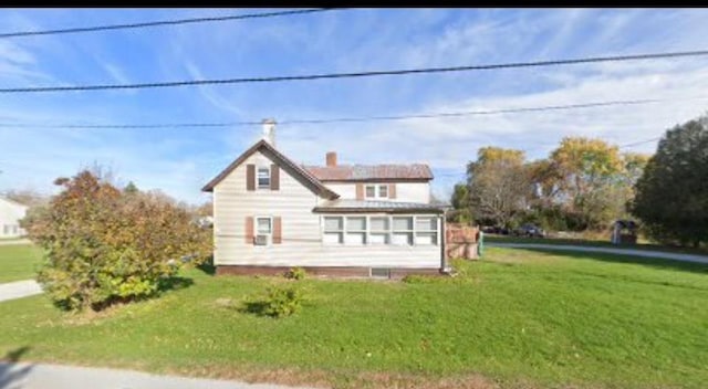 exterior space featuring a lawn and a chimney