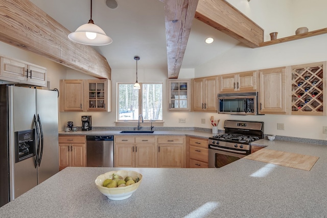 kitchen with light brown cabinets, vaulted ceiling with beams, glass insert cabinets, stainless steel appliances, and a sink