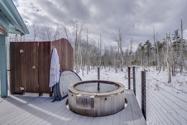 snow covered deck featuring a hot tub