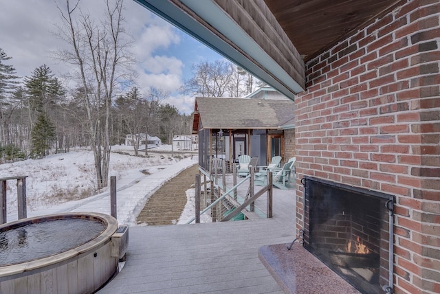 snow covered deck with a jacuzzi