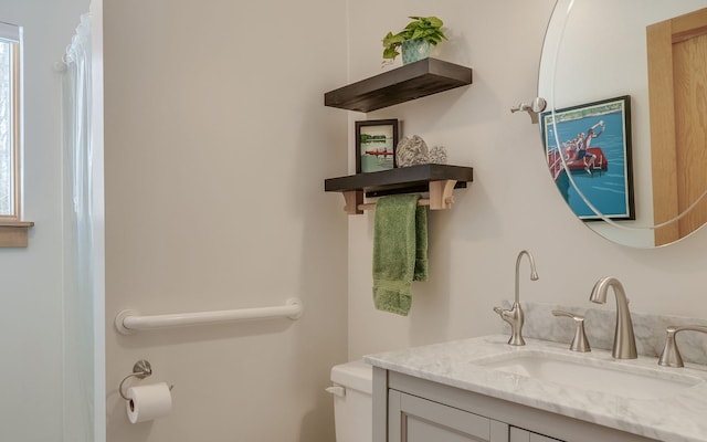 bathroom featuring toilet and vanity