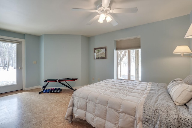 bedroom featuring baseboards, ceiling fan, and access to outside