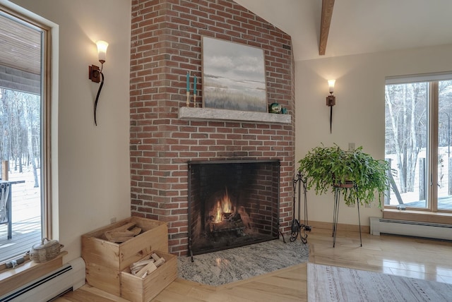 living room featuring a baseboard radiator, beamed ceiling, wood finished floors, and a fireplace