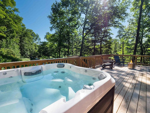 wooden deck featuring hot tub deck surround