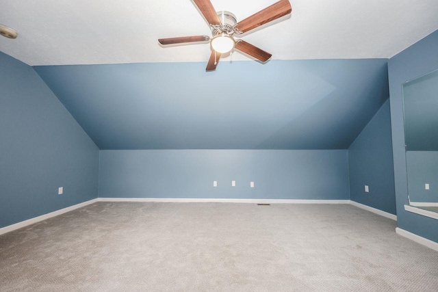 bonus room featuring baseboards, carpet, lofted ceiling, and a ceiling fan