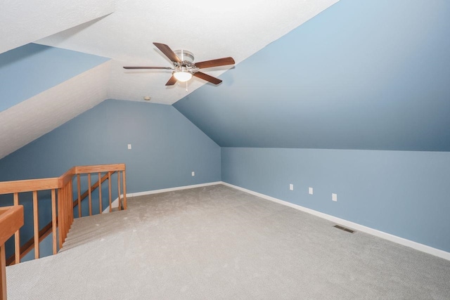 bonus room featuring visible vents, baseboards, carpet, and vaulted ceiling