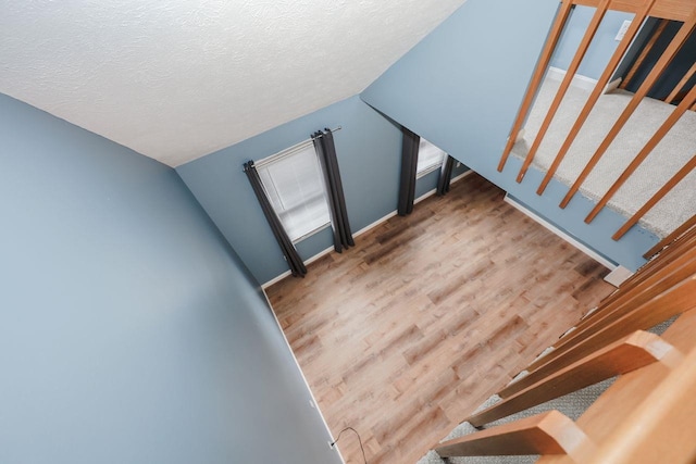 interior space with wood finished floors and a textured ceiling