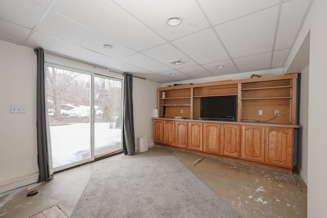 unfurnished living room featuring a drop ceiling, concrete floors, and visible vents