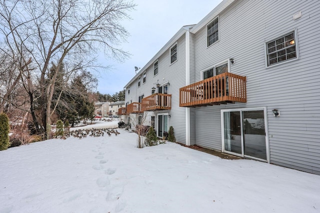 view of snow covered rear of property