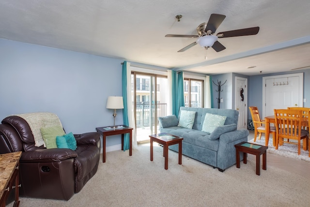 carpeted living room featuring ceiling fan