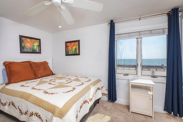 bedroom with light carpet and ceiling fan