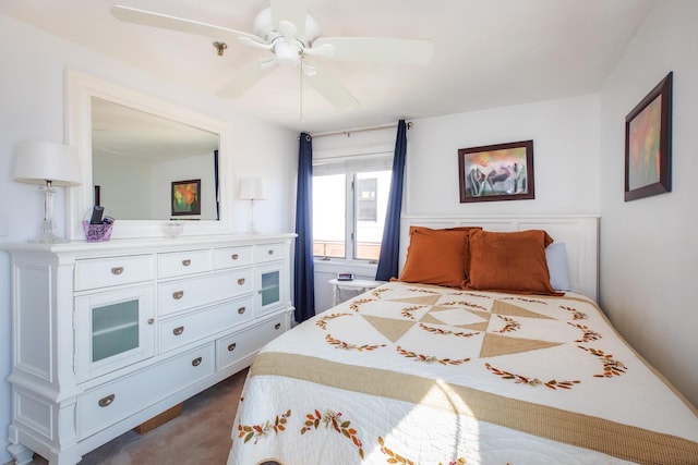 bedroom with ceiling fan and dark carpet