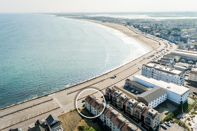 bird's eye view featuring a water view and a beach view