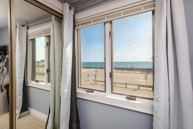 entryway with baseboards and a water view